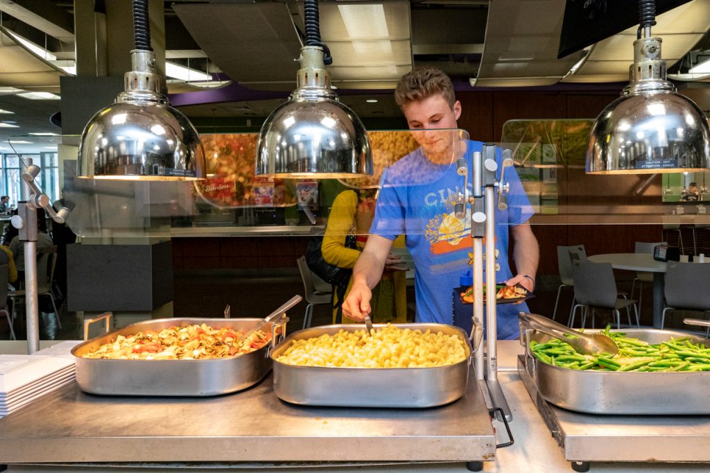 A student serves himself from the Lowcountry Kitchen station at Liberty Street dining hall