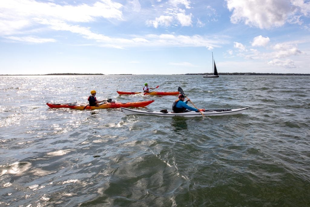 College of Charleston students participate in kayak rescue drills with the US Coast Guard.
