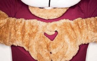 Clyde the cougar makes a heart shape with his hands