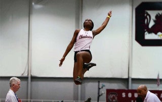Womens track and field member competes at a meet