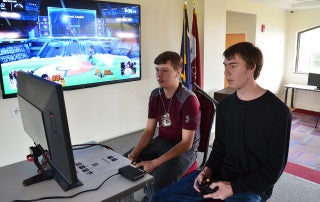 students in the esports club playing a video game