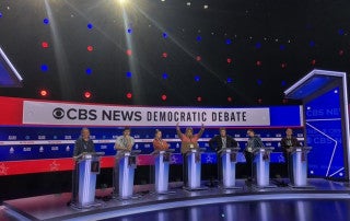 College of Charleston students serving as debate runners for the CBS News Democratic Debate stand-in for candidates on set at the Charleston Gaillard Center