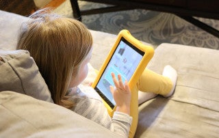 A child reads on an ipad