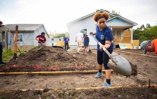 A student volunteers at habitat for humanity