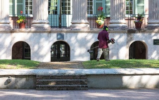 A Facilities Management groundskeeper trims the grass on the Cistern during the College's closure from the COVID-19 pandemic. April 8, 2020
