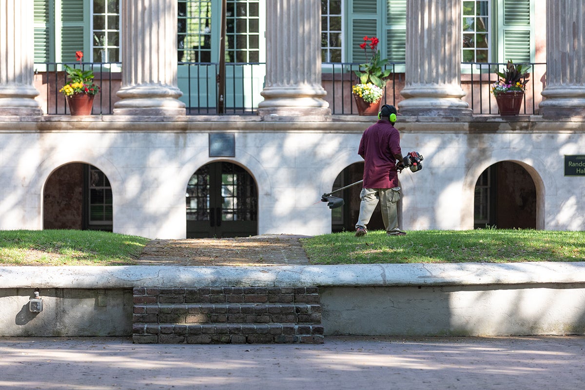 A Facilities Management groundskeeper trims the grass on the Cistern during the College's closure from the COVID-19 pandemic. April 8, 2020