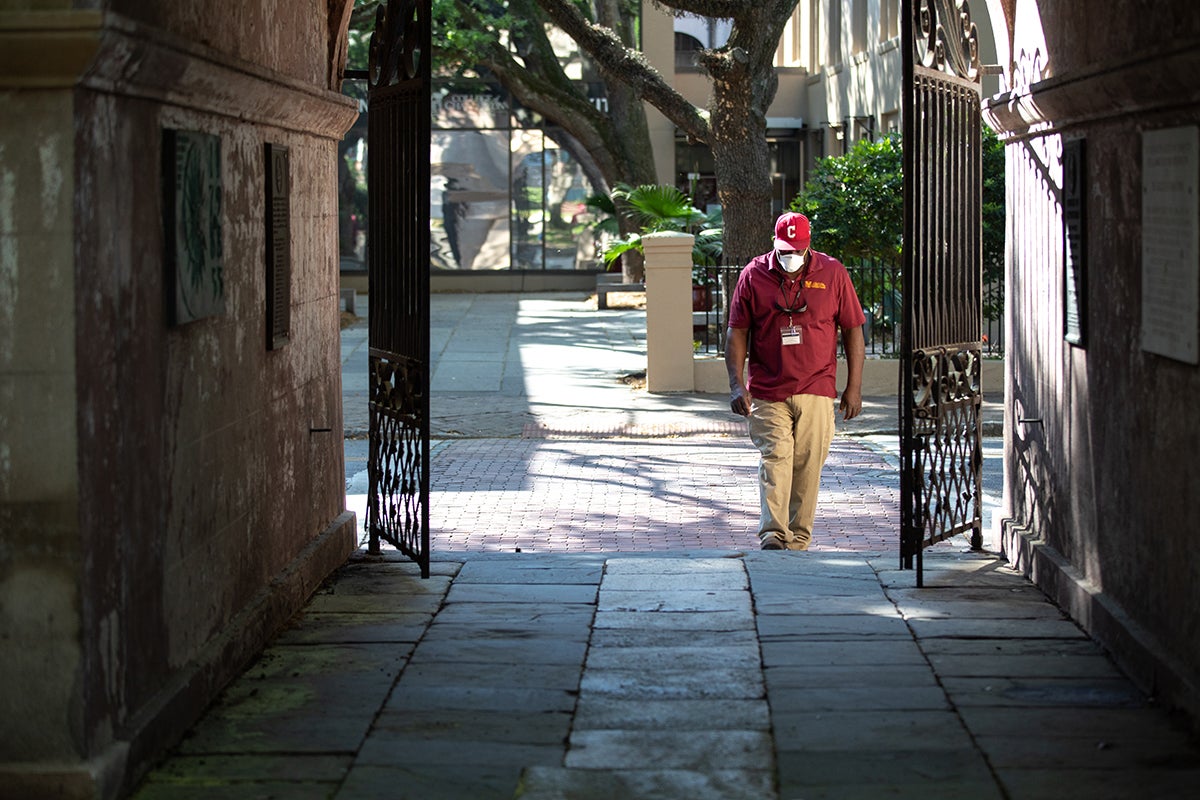Facilities Management Carpentry Shop Supervisor Sam Holmes walks into Porter's Lodge to start hanging 250th Plaques on the College's campus buildings during the College's closure from the COVID-19 pandemic. April 8, 2020
