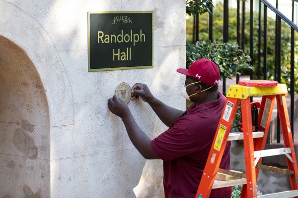 Sam Holmes the Carpentry Shop Supervisor, places the 250th Plaque on Randolph Hall. April 8, 2020