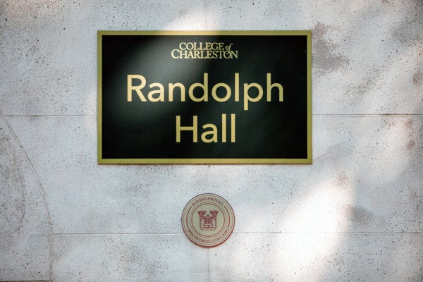 a medallion under the sign for Randolph Hall