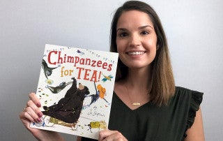 Lauren Croghan reads a book titled Champanzees for tea