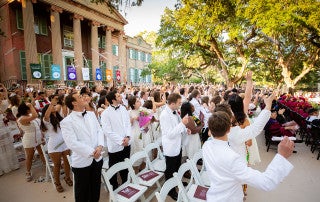 graduates throw diplomas in the air