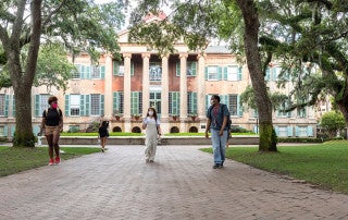 students wearing masks walk in cistern yard