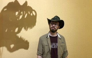 scott persons looks at the shadow of dinosaur