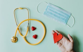 a stethoscope, face mask and hearts