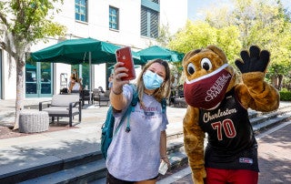 President Hsu & Clyde Hand Out Masks and hand sanitizer to students on campus.