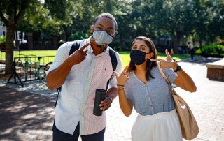 Students, faculty and staff all wearing masks on campus.