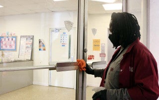 barbara simmons cleans a door at college lodge