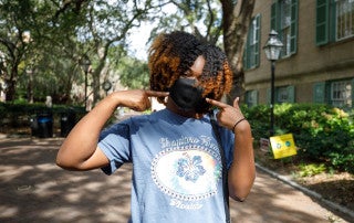 Student wearing mask on CofC campus.