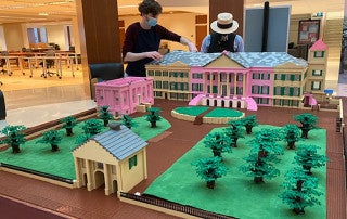 CofC students build a model of Cistern Yard with Legos at the Addlestone Library.