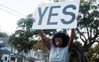 woman holding a yes sign
