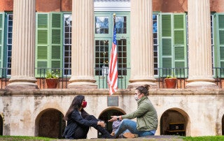 Two students convene on the Cistern in front of Randolph Hall, College of Charleston.