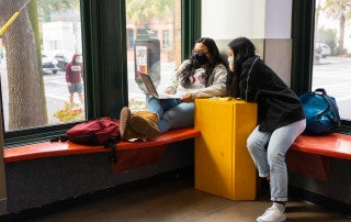 Students attend an online meeting in a small study space, The Halsey Gallery, College of Charleston.