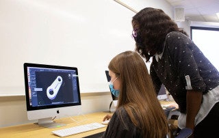 a student works with a professor to learn cad stoftware