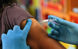 a person gets a vaccine shot in the arm