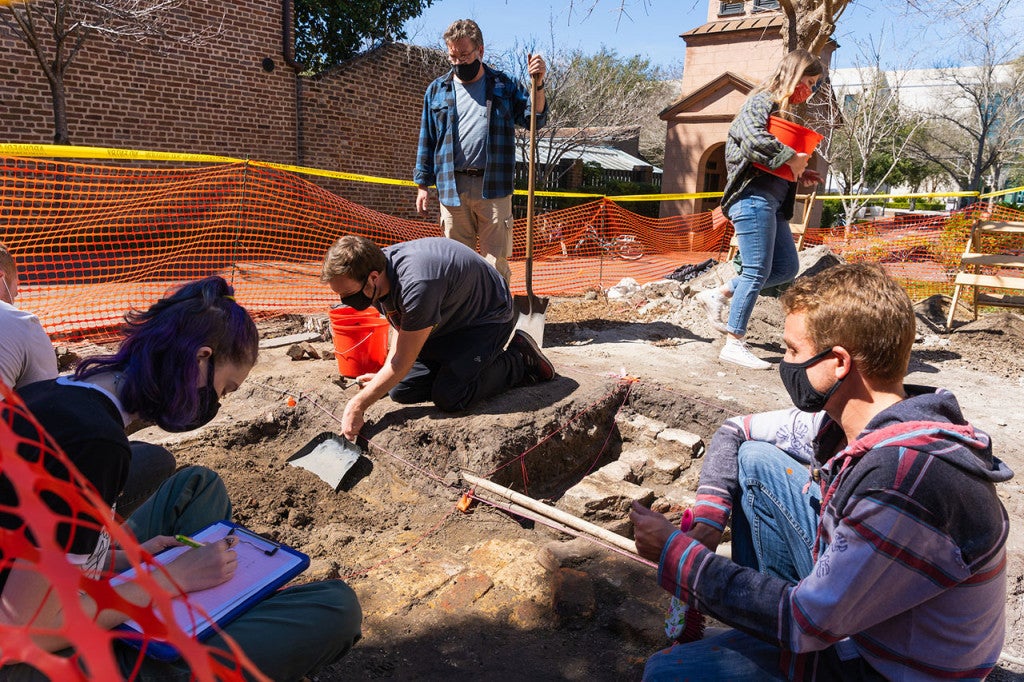 Student volunteers work at a dig site on the College of Charleston campus.
