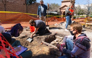 Student volunteers work at a dig site on the College of Charleston campus.