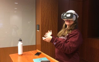 a student uses VR goggles