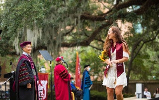 a student celebrates commencement at the college of charleston