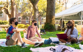 students studying outside with face masks on