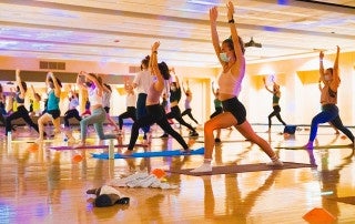 Students stretch and breathe at Glowga, part of College of Charleston's Weeks of Welcome.