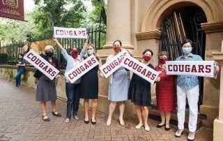 staff with Cougars signs