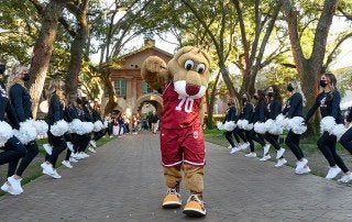 clyde the cougar with cheerleaders