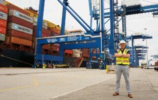 jep tanksley stands in front of shipping containers at sc ports