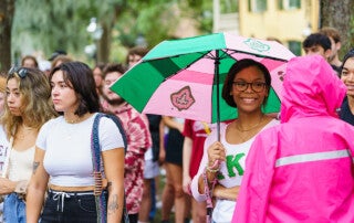 student with an umbrella at convocation