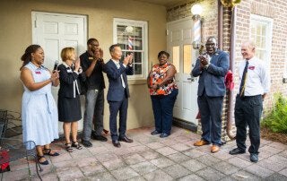 cofc officials cheer at the opening of cougar cutz barbershop