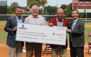 cofc officials hold a ceremonial check for new baseball performance center
