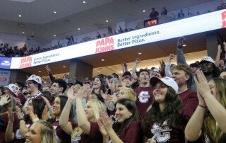 students cheer at a basketball game