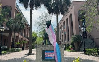 clyde the cougar statue wearing a trans flag