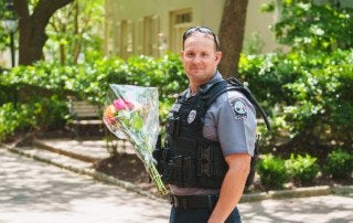 Public Safety Officer Holds Flowers at Graduation