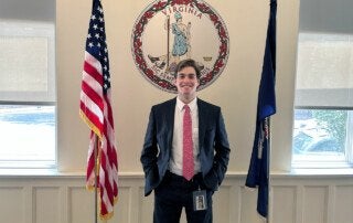 michael stein stands in front of the virginia state seal