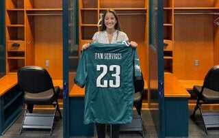 a woman holds a football jersey