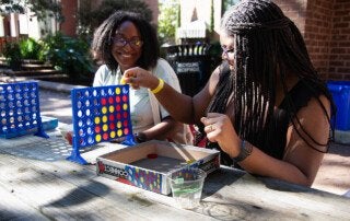 students playing connect four together