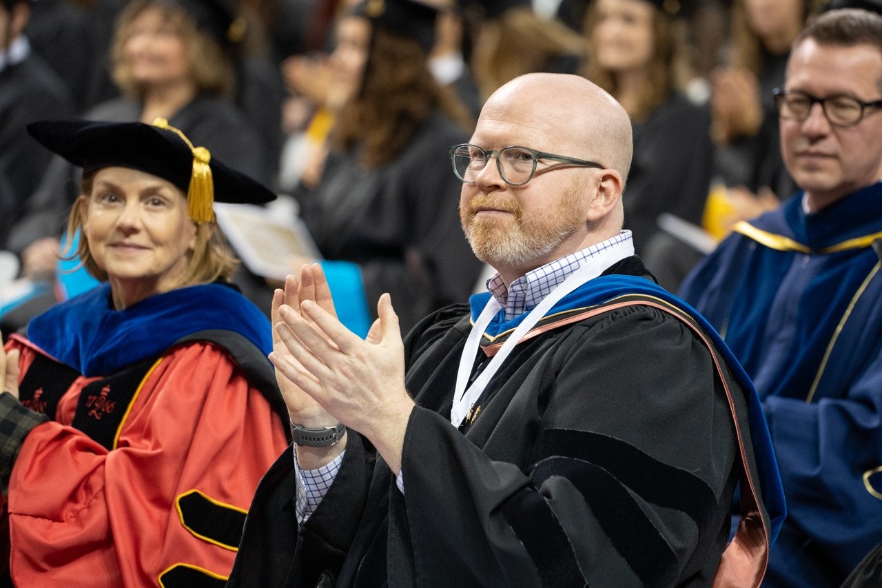 faculty claps for graduates