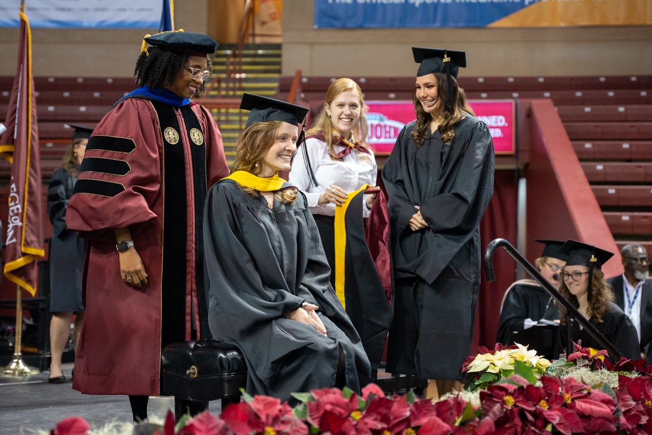 grad student receives diploma