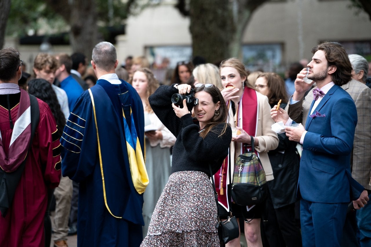 family takes photos after winter commencement in cistern yard
