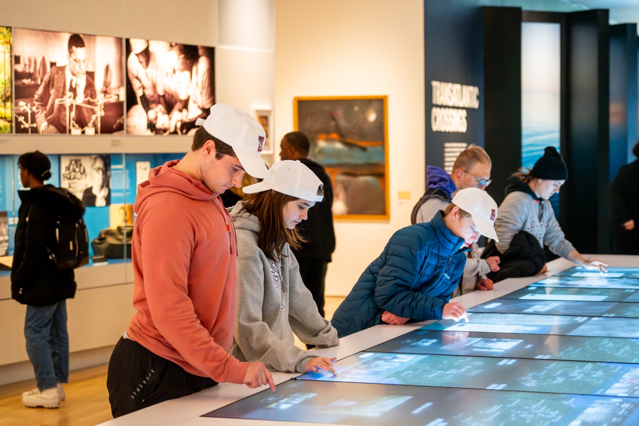 students looks at interactive exhibit at IAAM